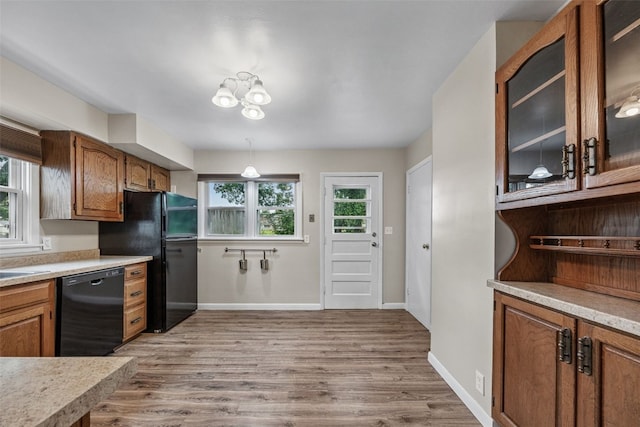 2539 Vernon Ct SE, Cedar Rapids, IA 52403 - kitchen with black appliances, light wood-type flooring, and light countertops