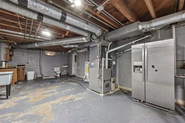 2539 Vernon Ct SE, Cedar Rapids, IA 52403 - unfinished basement featuring stainless steel fridge, heating unit, and water heater