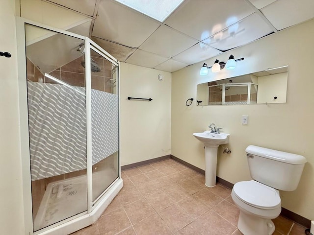 423 S 7th Ave, Iowa City, IA 52245 - bathroom featuring a drop ceiling, a shower stall, and tile patterned floors