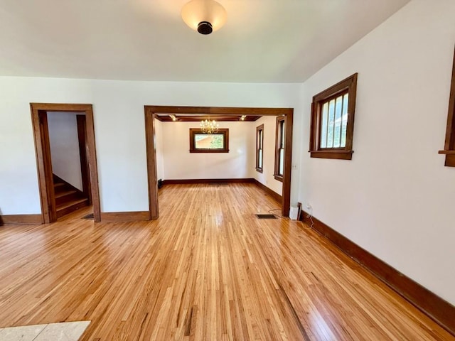 423 S 7th Ave, Iowa City, IA 52245 - spare room featuring a chandelier and light wood-style floors