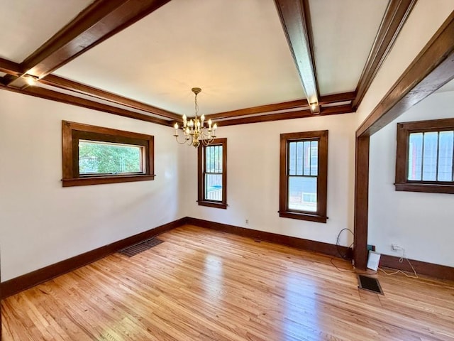 423 S 7th Ave, Iowa City, IA 52245 - empty room featuring beamed ceiling, light wood-style floors, and a chandelier