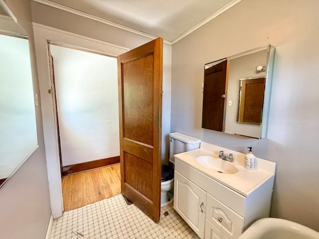 423 S 7th Ave, Iowa City, IA 52245 - bathroom featuring vanity, wood finished floors, and ornamental molding