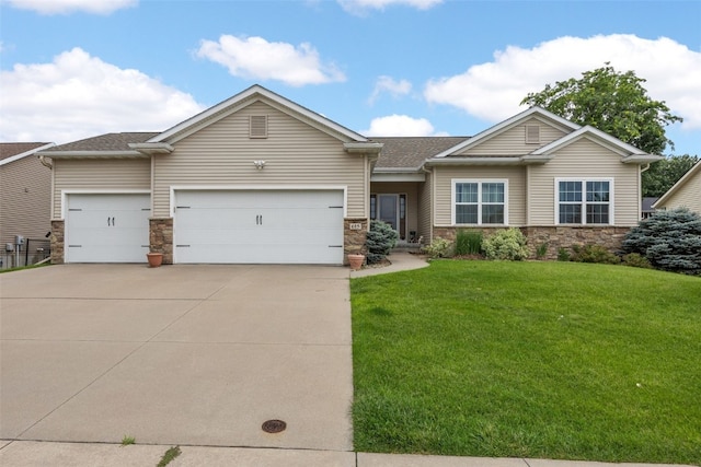 615 34th Ave, Marion, IA 52302 - view of front facade featuring stone siding, an attached garage, a front yard, and concrete driveway