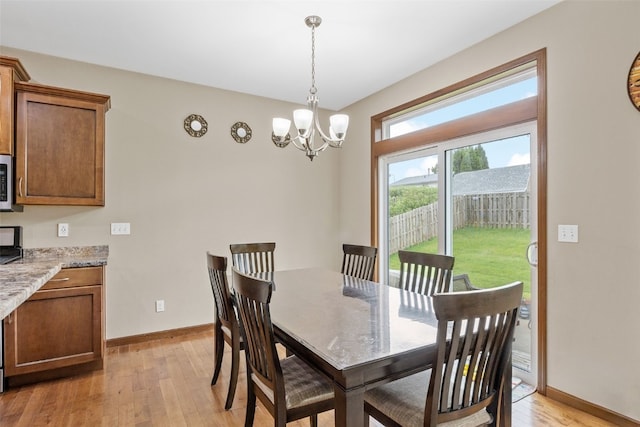 615 34th Ave, Marion, IA 52302 - dining room with light wood-style floors and a chandelier