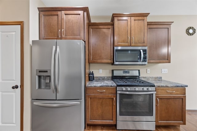 615 34th Ave, Marion, IA 52302 - kitchen featuring appliances with stainless steel finishes, brown cabinets, and wood finished floors