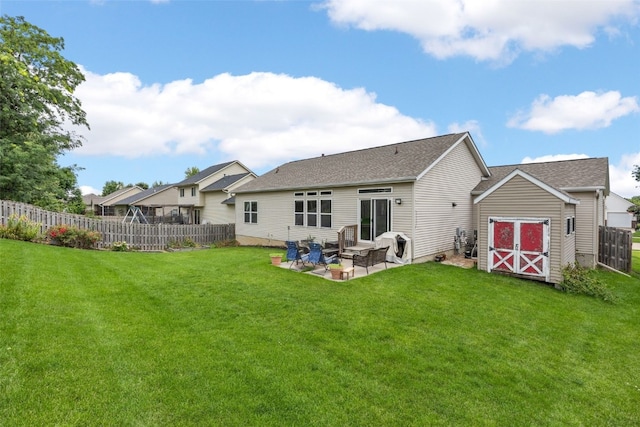 615 34th Ave, Marion, IA 52302 - back of property with a patio, a storage unit, and a shingled roof