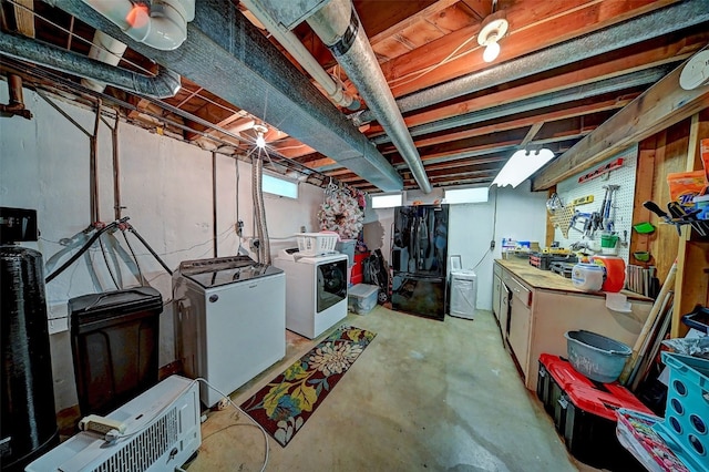 1175 28th St, Marion, IA 52302 - below grade area featuring separate washer and dryer, fridge, and freestanding refrigerator
