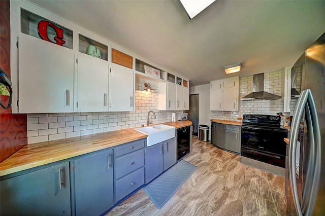 1175 28th St, Marion, IA 52302 - kitchen featuring wall chimney exhaust hood, black appliances, wood counters, decorative backsplash, and open shelves