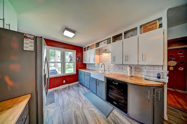 1175 28th St, Marion, IA 52302 - kitchen with stainless steel refrigerator with ice dispenser, dishwasher, wooden counters, and white cabinets