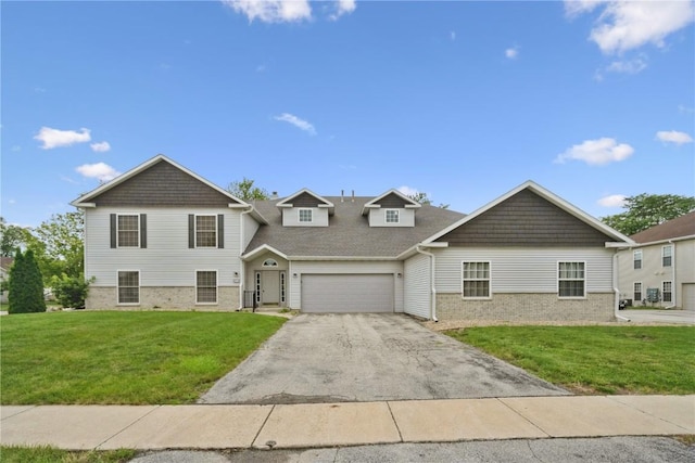 4555 Westchester Dr NE Unit B, Cedar Rapids, IA 52402 - view of front facade with asphalt driveway, a front lawn, brick siding, and a garage