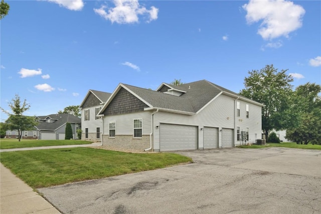 4555 Westchester Dr NE Unit B, Cedar Rapids, IA 52402 - view of side of property featuring driveway, a lawn, brick siding, and an attached garage