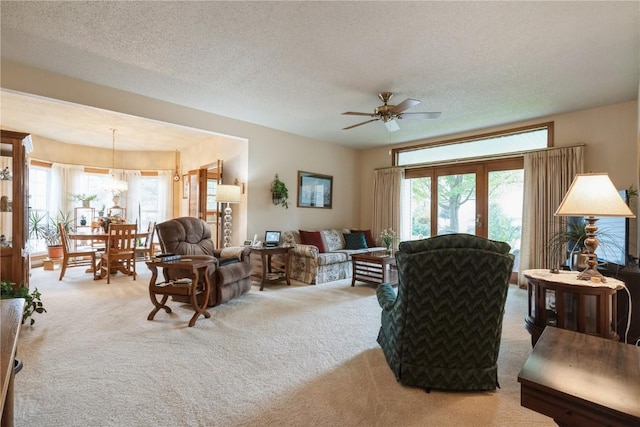 4555 Westchester Dr NE Unit B, Cedar Rapids, IA 52402 - living room featuring carpet, healthy amount of natural light, ceiling fan, and a textured ceiling