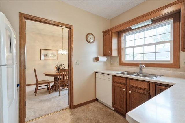4555 Westchester Dr NE Unit B, Cedar Rapids, IA 52402 - kitchen featuring white appliances, light colored carpet, light countertops, and brown cabinetry