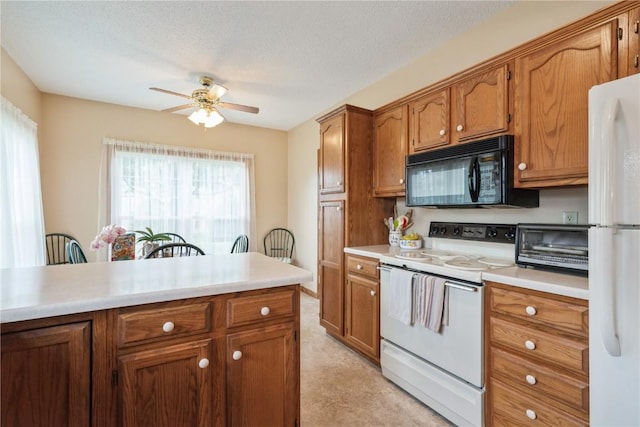 4555 Westchester Dr NE Unit B, Cedar Rapids, IA 52402 - kitchen featuring white appliances, a ceiling fan, brown cabinets, light countertops, and light carpet