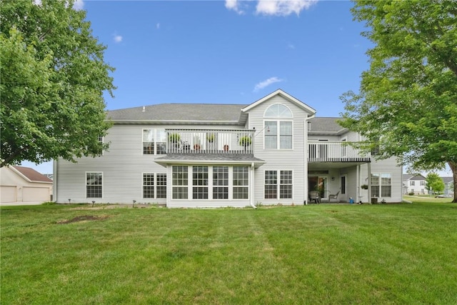 4555 Westchester Dr NE Unit B, Cedar Rapids, IA 52402 - back of property with a balcony, a lawn, and a sunroom