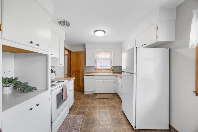 360 29th St NW, Cedar Rapids, IA 52405 - kitchen featuring white appliances, white cabinetry, and light countertops