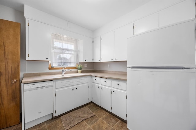 360 29th St NW, Cedar Rapids, IA 52405 - kitchen featuring white appliances, white cabinetry, light countertops, and dark stone finish floors