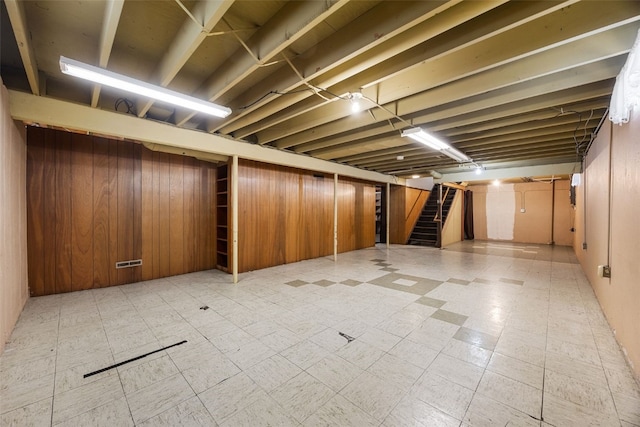 360 29th St NW, Cedar Rapids, IA 52405 - finished below grade area with stairway, light floors, and wooden walls