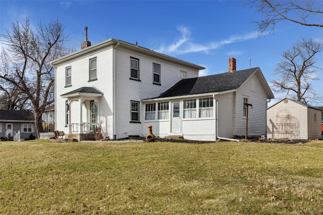 1860 E Ave NW, Cedar Rapids, IA 52405 - rear view of property featuring a chimney and a yard