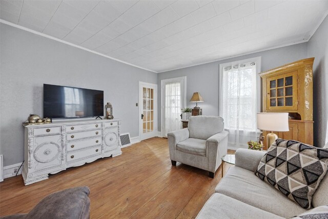 1860 E Ave NW, Cedar Rapids, IA 52405 - living area featuring crown molding and hardwood / wood-style floors