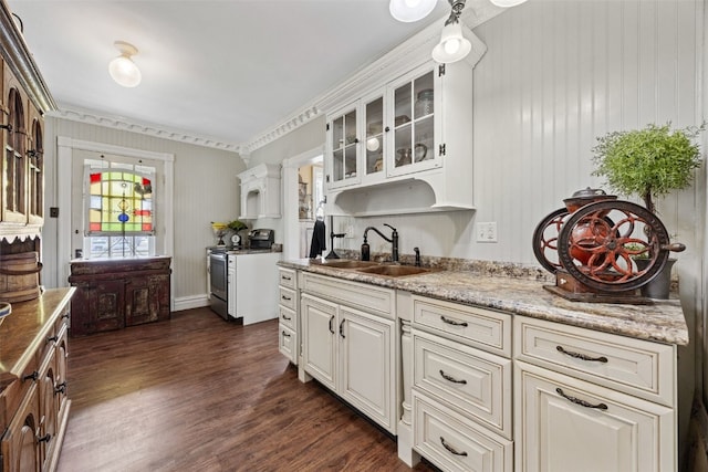 1860 E Ave NW, Cedar Rapids, IA 52405 - kitchen with stainless steel range with electric cooktop, dark wood-type flooring, glass insert cabinets, white cabinetry, and ornamental molding