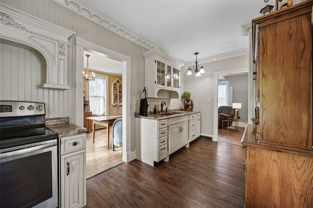1860 E Ave NW, Cedar Rapids, IA 52405 - kitchen featuring a chandelier, stainless steel electric range, dark wood-style floors, glass insert cabinets, and hanging light fixtures