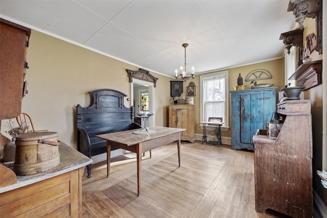 1860 E Ave NW, Cedar Rapids, IA 52405 - dining area featuring crown molding, a chandelier, and light wood-style flooring