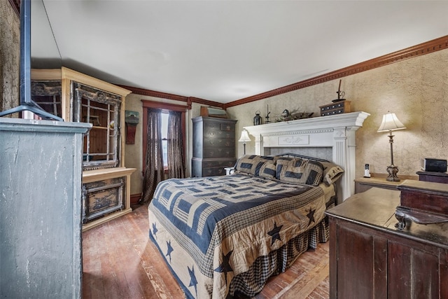 1860 E Ave NW, Cedar Rapids, IA 52405 - bedroom with wood finished floors, a fireplace, and ornamental molding