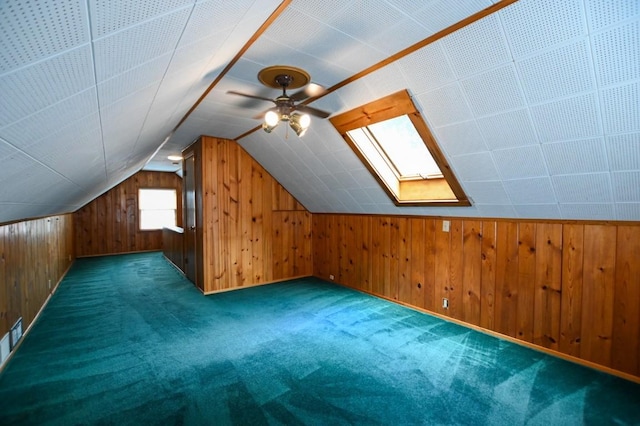 1135 Maplecrest Dr, Marion, IA 52302 - additional living space with wooden walls, a ceiling fan, carpet floors, lofted ceiling, and a skylight