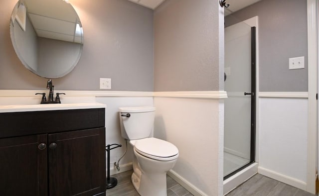 1135 Maplecrest Dr, Marion, IA 52302 - bathroom featuring vanity, a stall shower, and wood finished floors