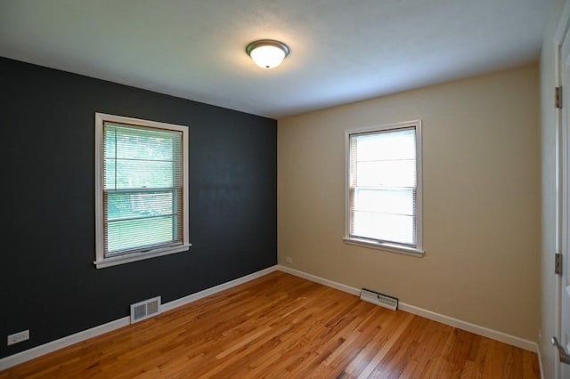 1135 Maplecrest Dr, Marion, IA 52302 - unfurnished room featuring healthy amount of natural light and light wood finished floors