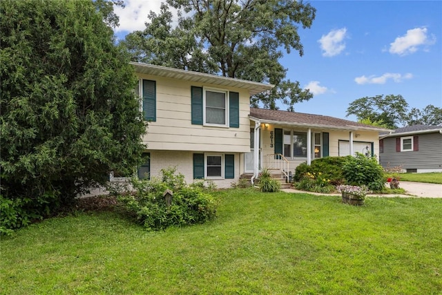 6613 Devonshire Dr NE, Cedar Rapids, IA 52402 - tri-level home with a garage, a front yard, driveway, and brick siding