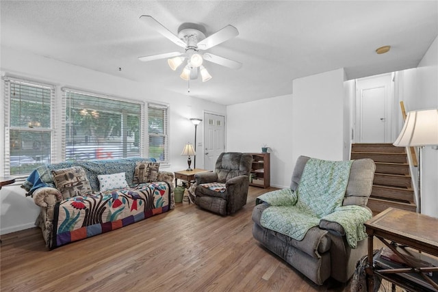 6613 Devonshire Dr NE, Cedar Rapids, IA 52402 - living area featuring wood finished floors, ceiling fan, and stairs