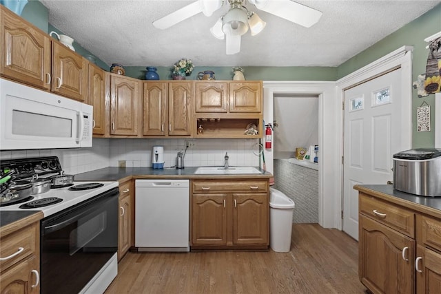 6613 Devonshire Dr NE, Cedar Rapids, IA 52402 - kitchen featuring white appliances, light wood finished floors, a textured ceiling, ceiling fan, and dark countertops