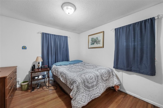 6613 Devonshire Dr NE, Cedar Rapids, IA 52402 - bedroom with wood finished floors and a textured ceiling