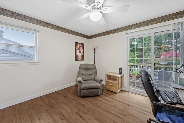 6613 Devonshire Dr NE, Cedar Rapids, IA 52402 - office area with light wood finished floors and a ceiling fan
