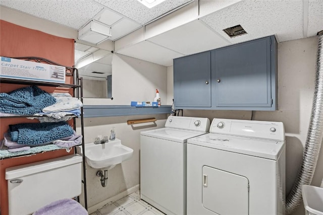 6613 Devonshire Dr NE, Cedar Rapids, IA 52402 - laundry room with cabinet space, washer and dryer, and light floors