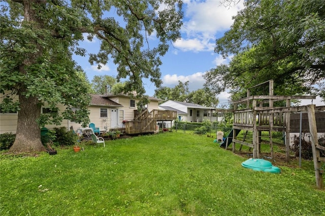 6613 Devonshire Dr NE, Cedar Rapids, IA 52402 - fenced backyard with a playground and a deck