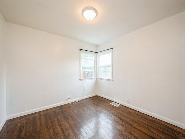 2408 J St SW, Cedar Rapids, IA 52404 - empty room featuring dark wood finished floors and baseboards