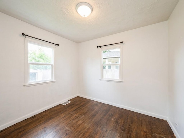 2408 J St SW, Cedar Rapids, IA 52404 - spare room featuring dark wood-style floors and a textured ceiling
