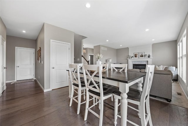 2455 Bridlewood Ct, Marion, IA 52302 - dining space featuring dark wood-type flooring, recessed lighting, and a fireplace