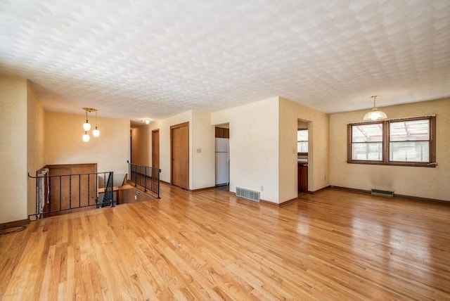 2029 Knollshire Rd NE, Cedar Rapids, IA 52402 - unfurnished living room with light wood-style floors and baseboards