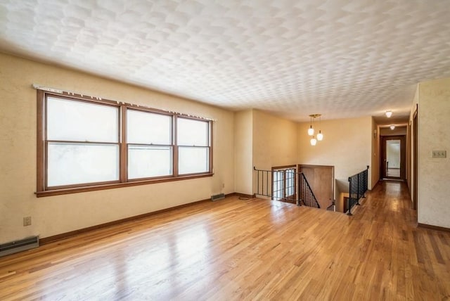 2029 Knollshire Rd NE, Cedar Rapids, IA 52402 - spare room featuring wood finished floors and baseboards