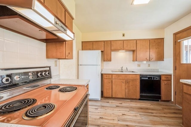 2029 Knollshire Rd NE, Cedar Rapids, IA 52402 - kitchen with electric range oven, freestanding refrigerator, black dishwasher, custom exhaust hood, and light wood-type flooring