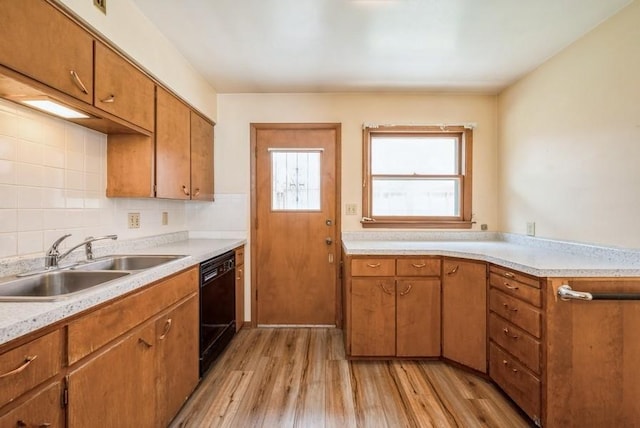 2029 Knollshire Rd NE, Cedar Rapids, IA 52402 - kitchen featuring dishwasher, light wood-style flooring, light countertops, and brown cabinets