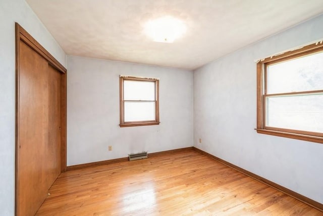 2029 Knollshire Rd NE, Cedar Rapids, IA 52402 - unfurnished bedroom featuring light wood-style floors and a closet