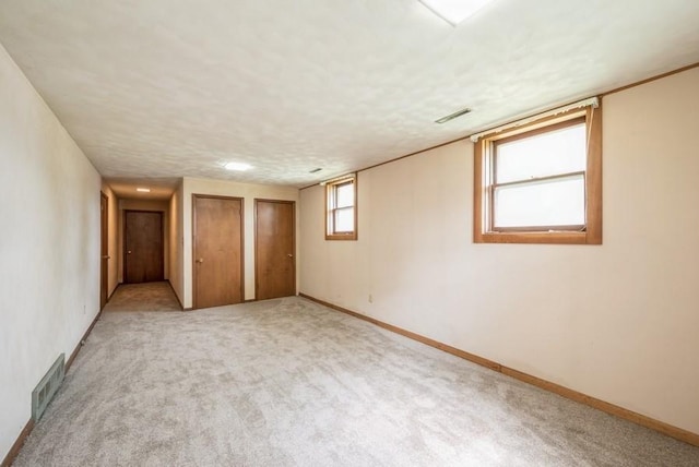 2029 Knollshire Rd NE, Cedar Rapids, IA 52402 - unfurnished bedroom featuring two closets and light carpet