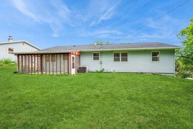 2029 Knollshire Rd NE, Cedar Rapids, IA 52402 - rear view of house with a sunroom and a lawn