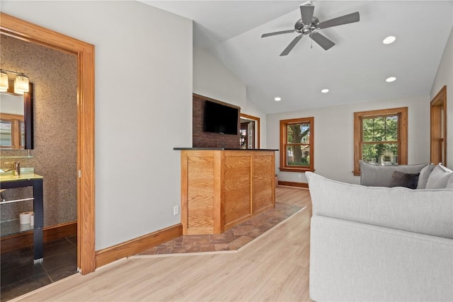 2021 Bever Ave SE, Cedar Rapids, IA 52403 - living room featuring wood finished floors, vaulted ceiling, ceiling fan, and recessed lighting