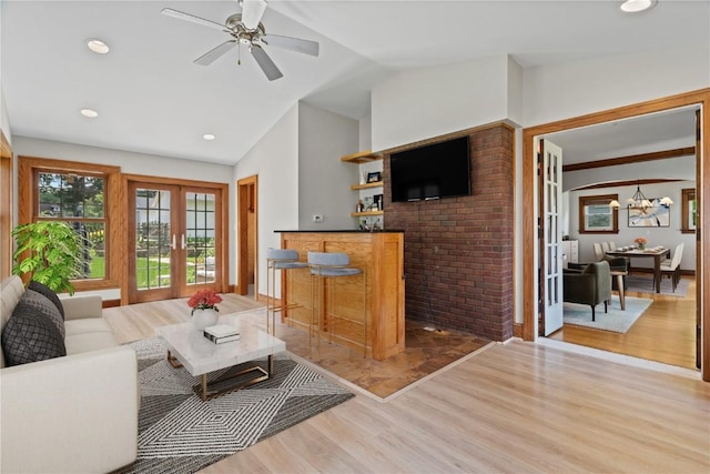 2021 Bever Ave SE, Cedar Rapids, IA 52403 - living area with light wood-type flooring, a chandelier, a ceiling fan, a bar, and recessed lighting